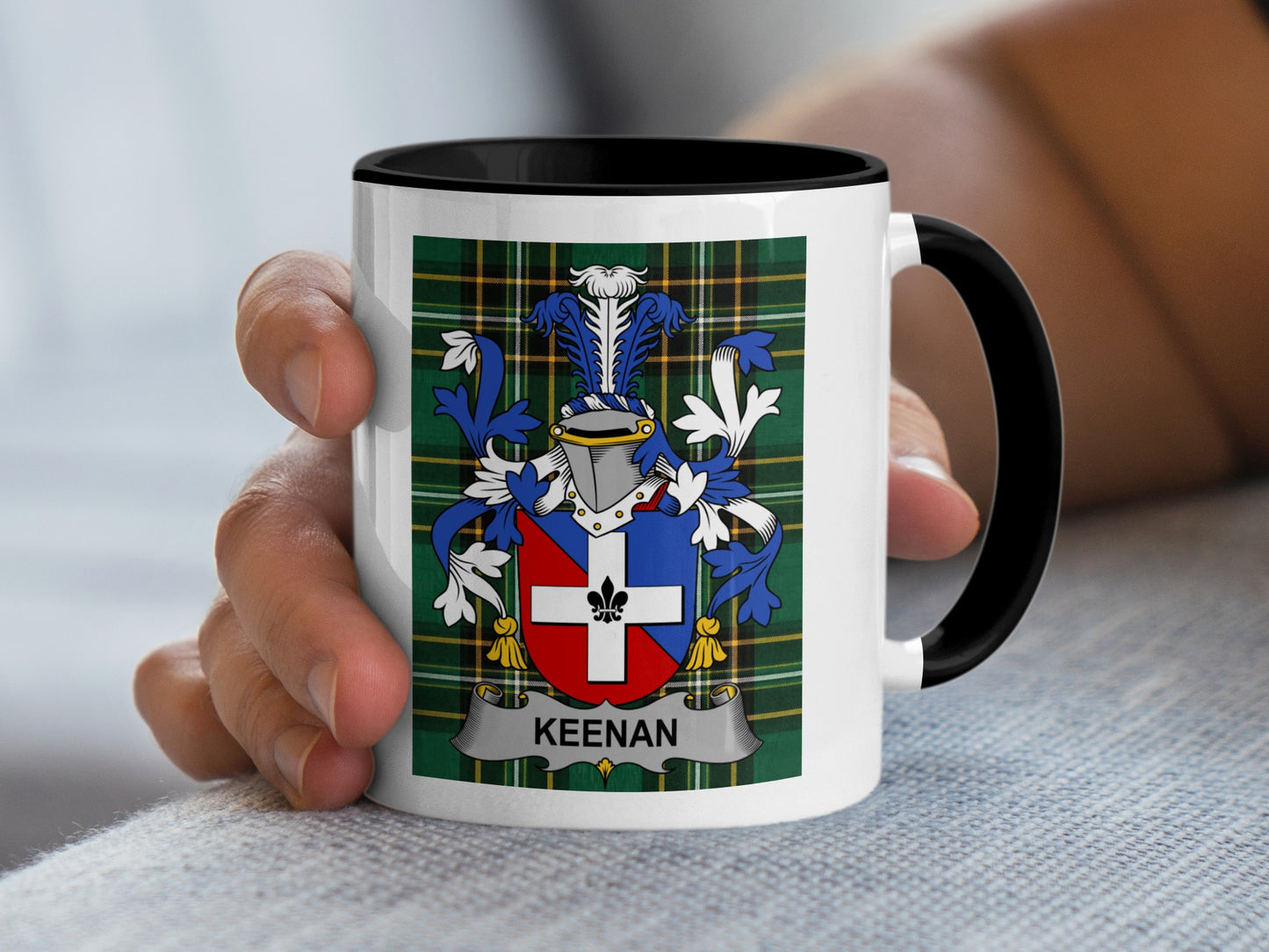 White mug with black handle displaying a crest with the name "KEENAN".