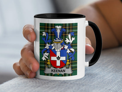 White mug with black handle displaying a crest with the name "KEENAN".