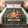 KEEVAN family crest on a green plaid throw blanket on a bed.