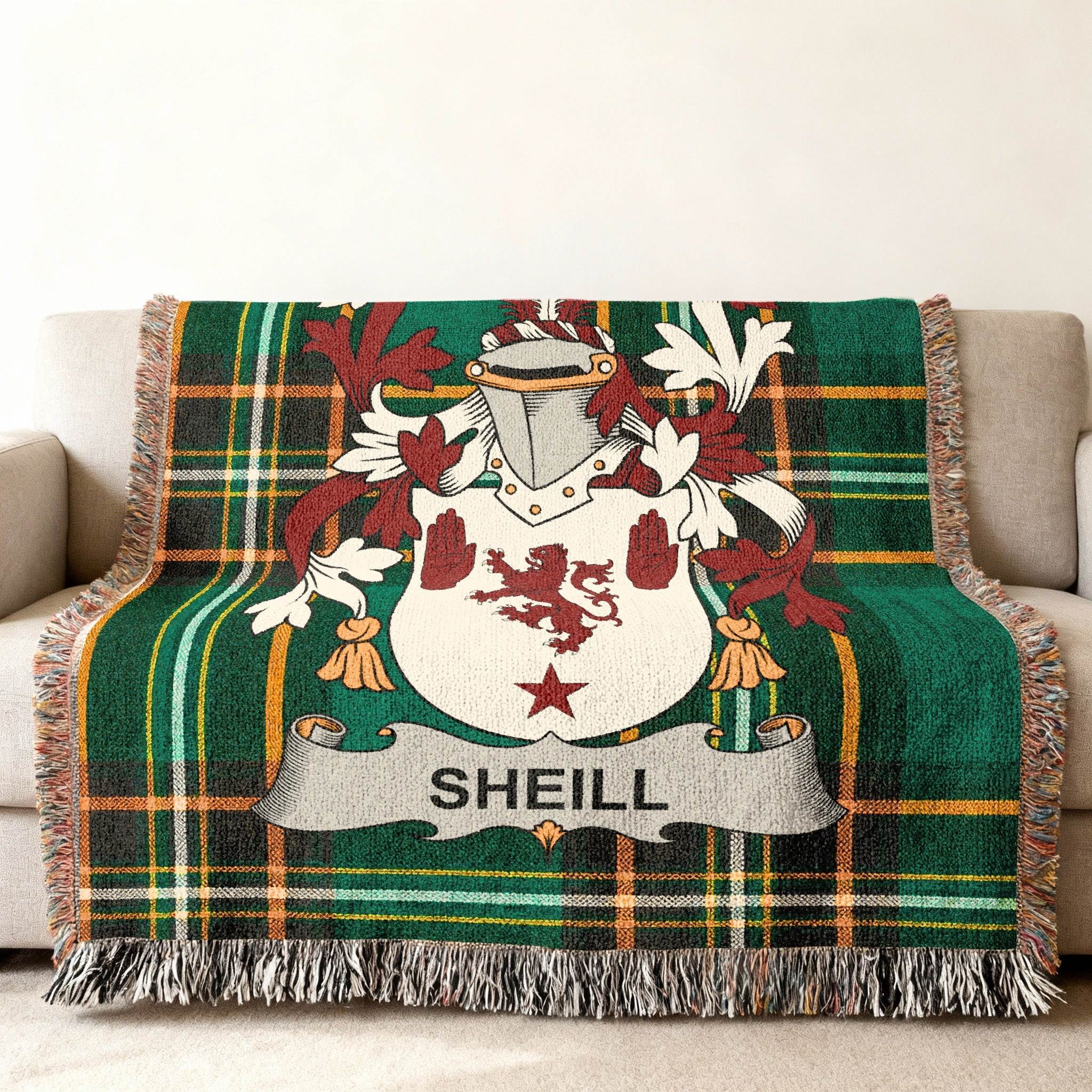 Green tartan throw blanket with a family crest featuring the name SHEILL.