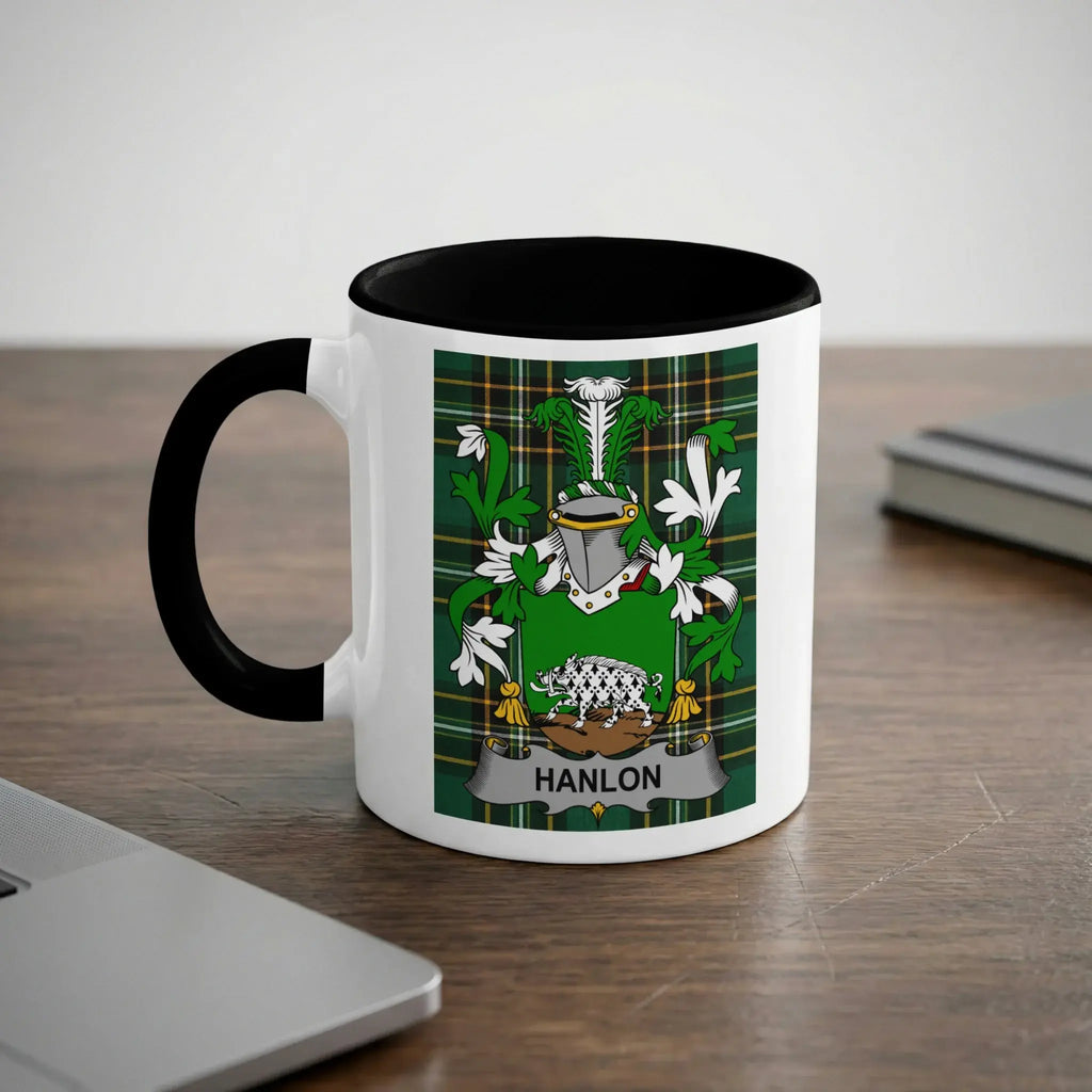 White mug with black rim featuring a green and yellow family crest with the name "HANLON".
