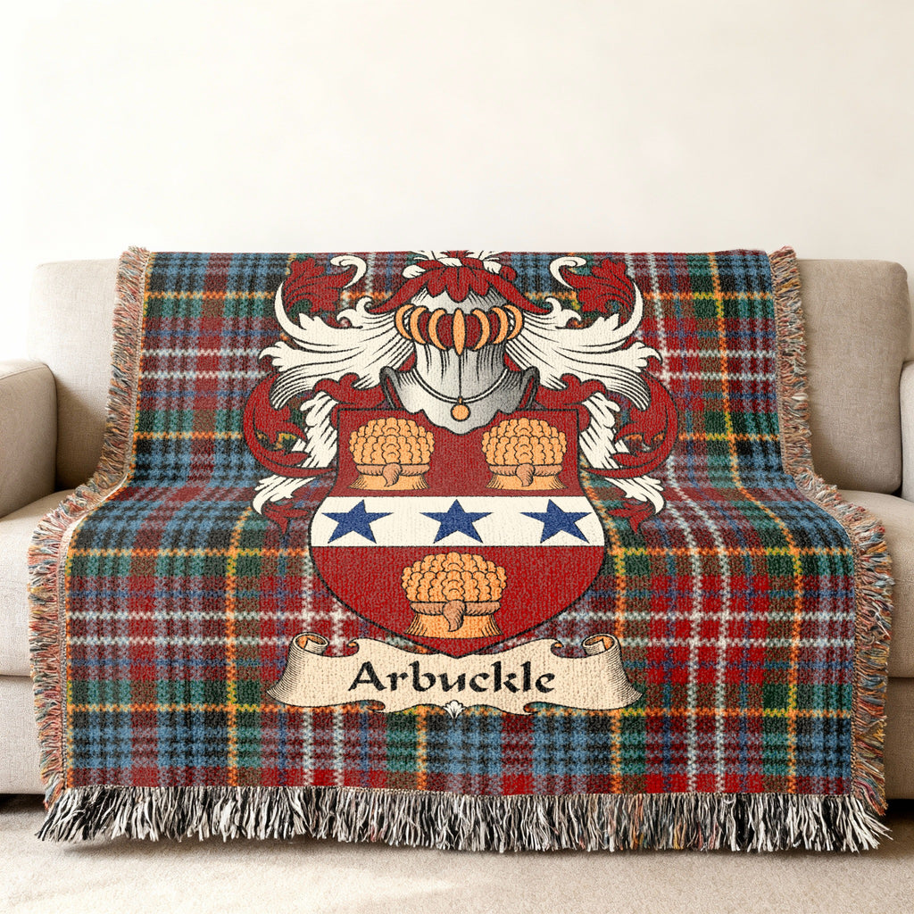 Arbuckle Scottish family shield woven blanket with Caledonia tartan background on a sofa