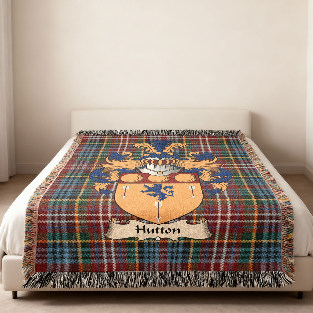 Hutton Scottish family shield woven blanket on a Caledonia tartan background