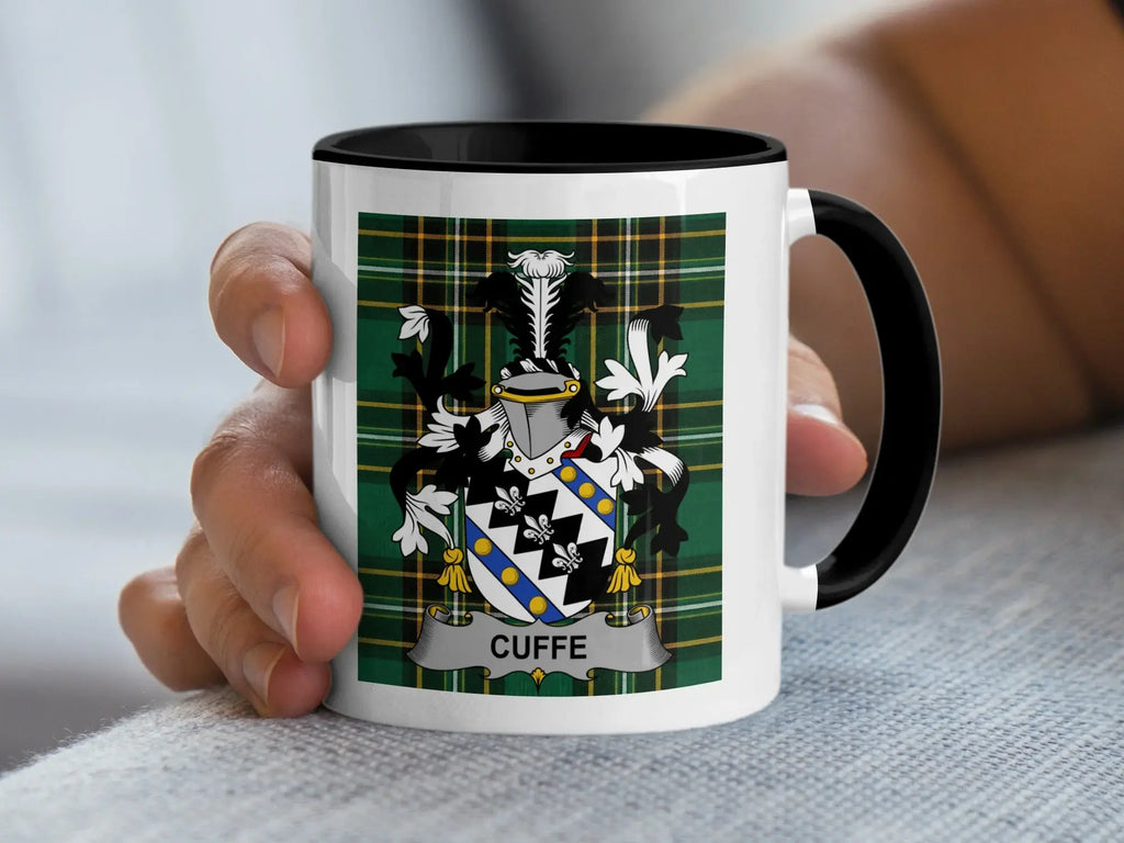 White mug with black rim featuring a tartan pattern and a coat of arms with the name "CUFFE".