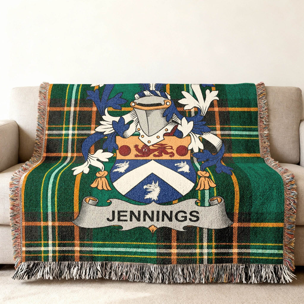 Woven green plaid throw blanket with Jennings family crest centered.