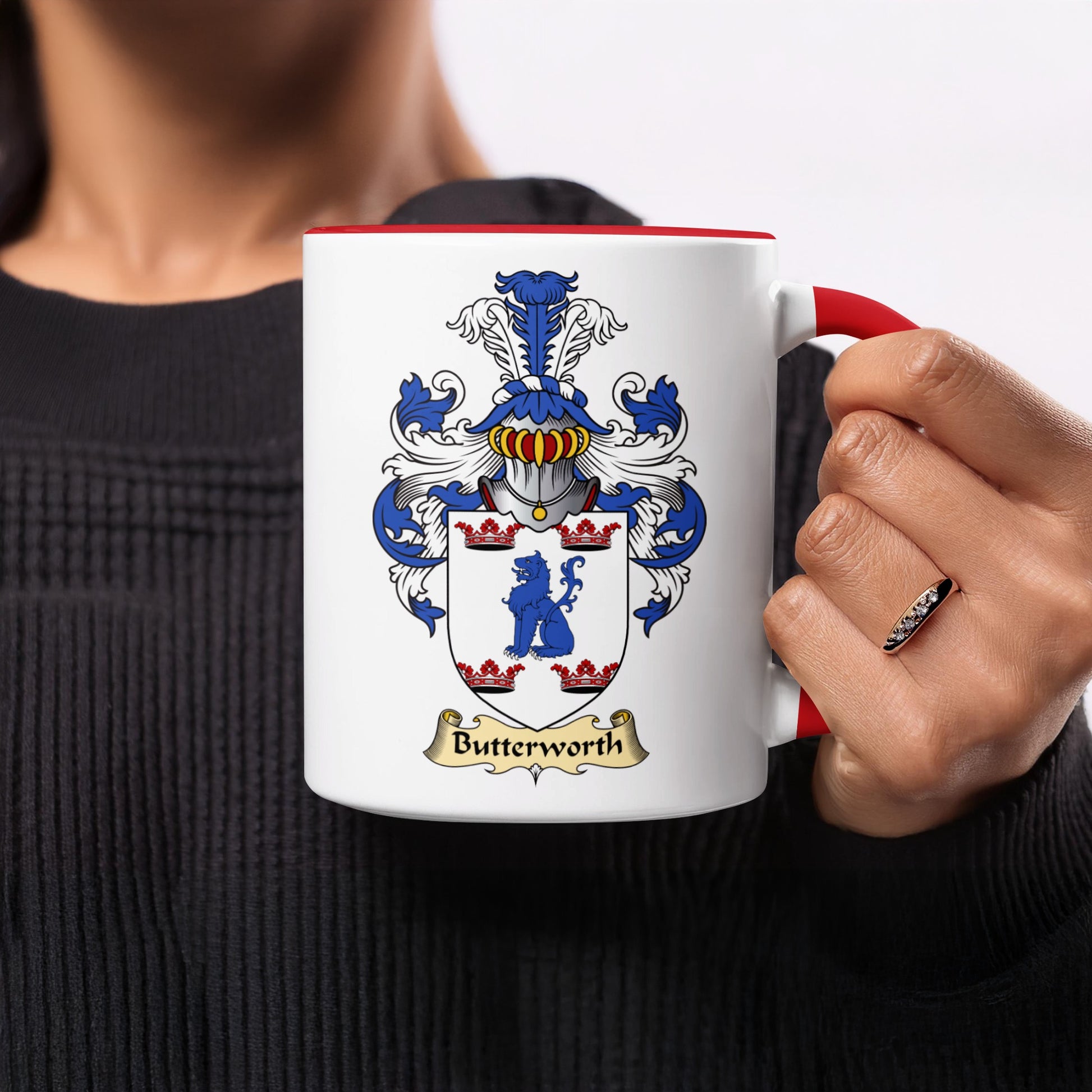 White mug with red handle featuring the Butterworth coat of arms.