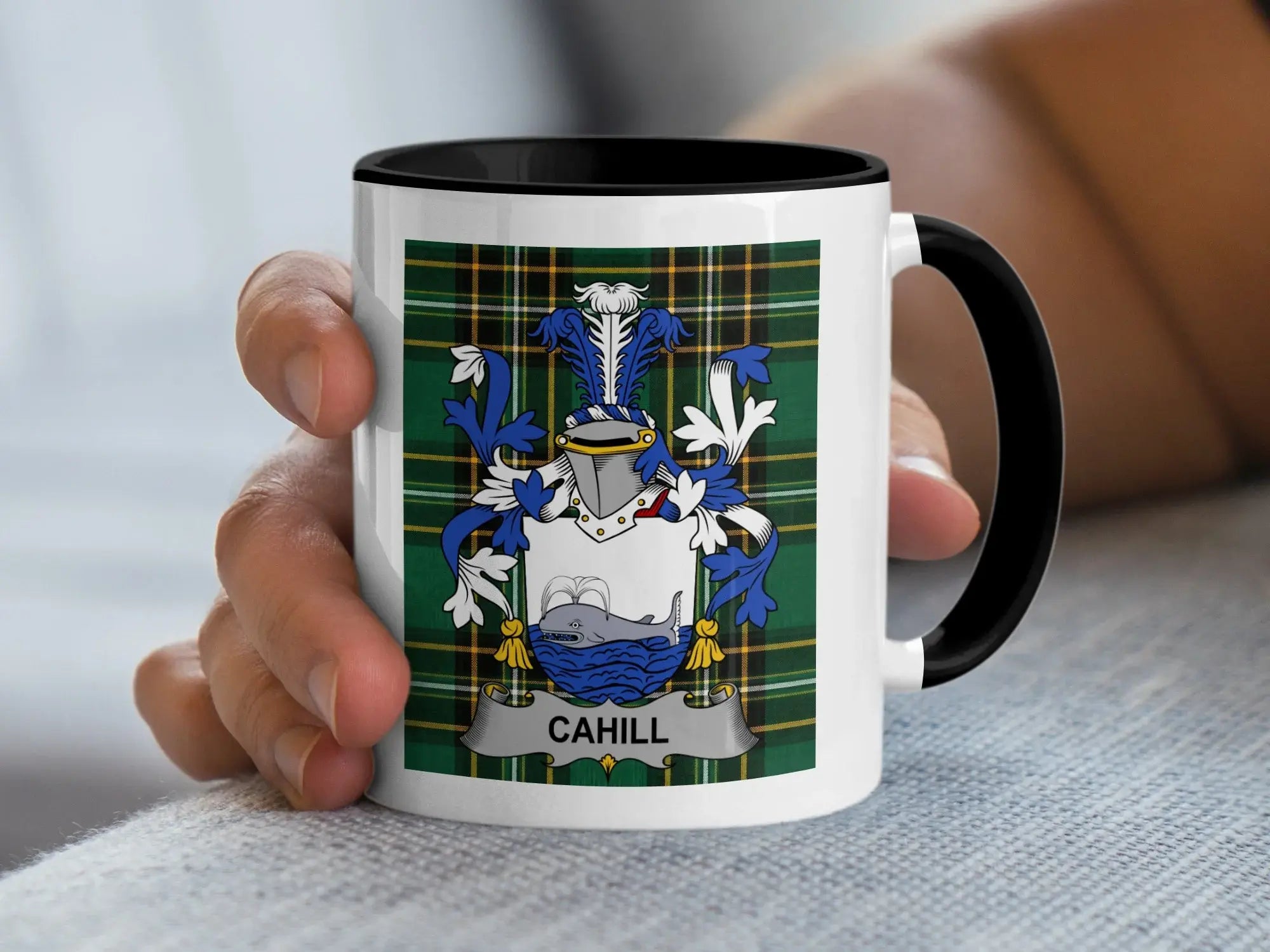 White mug with black handle featuring the Cahill family crest on a plaid background.