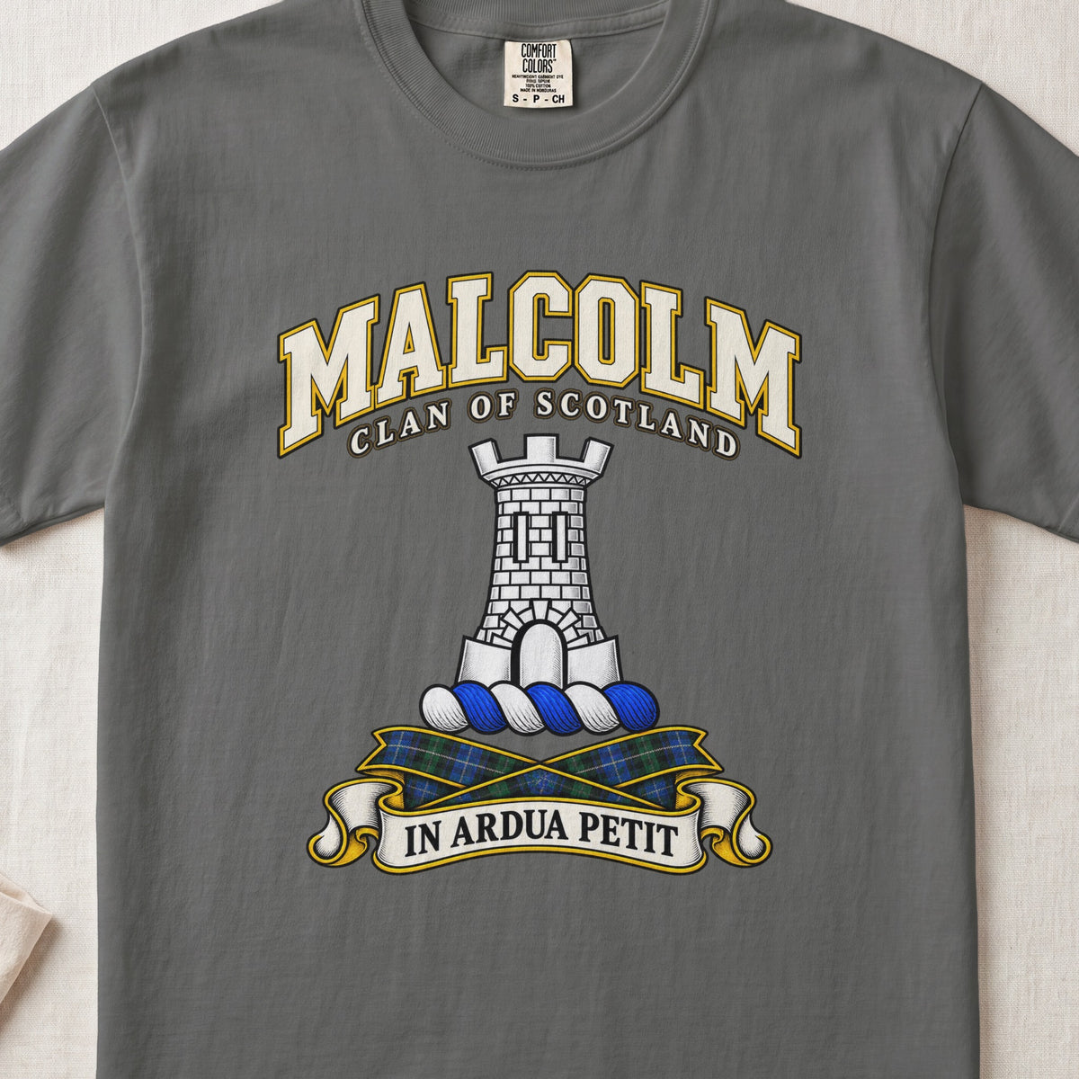 Malcolm Scottish clan T-shirt in Pepper, front view with a gray stone tower and motto banner.