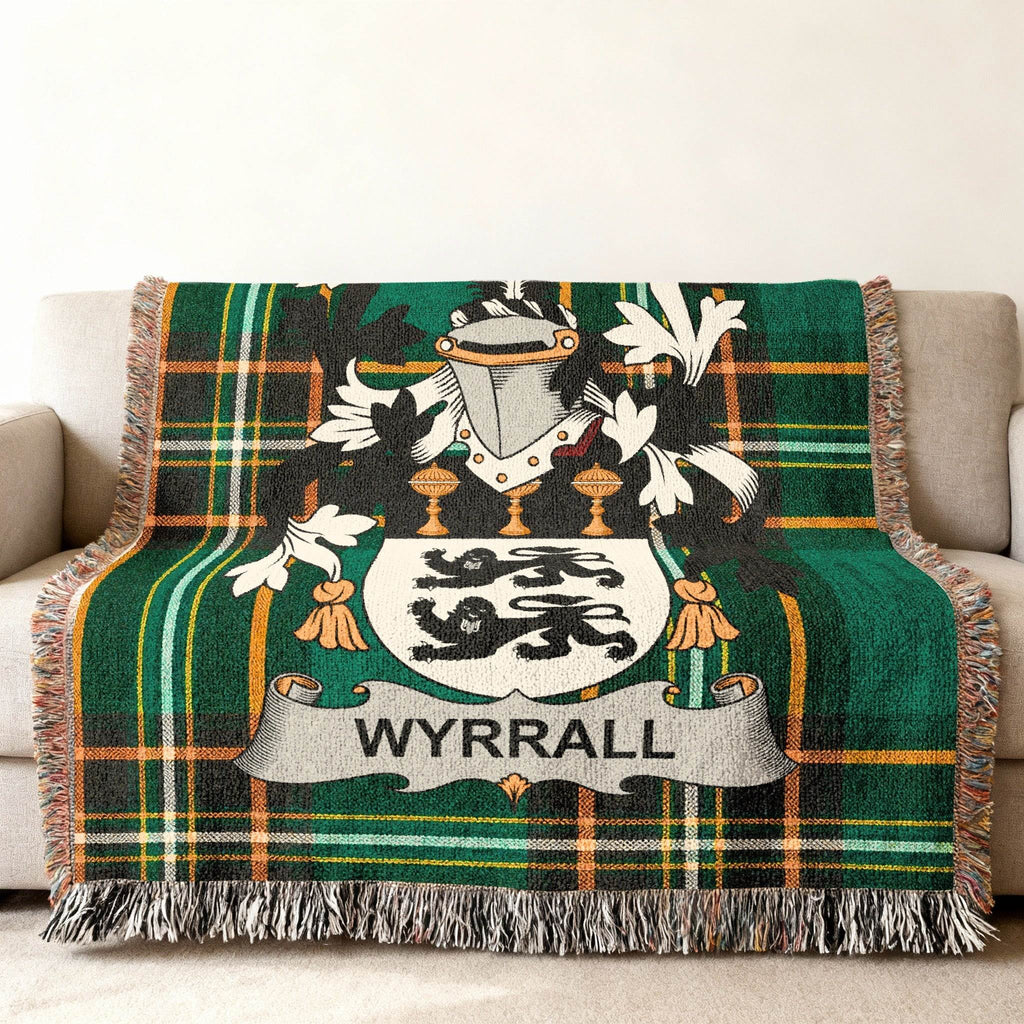 Wyrrall family crest on a green tartan woven throw blanket.