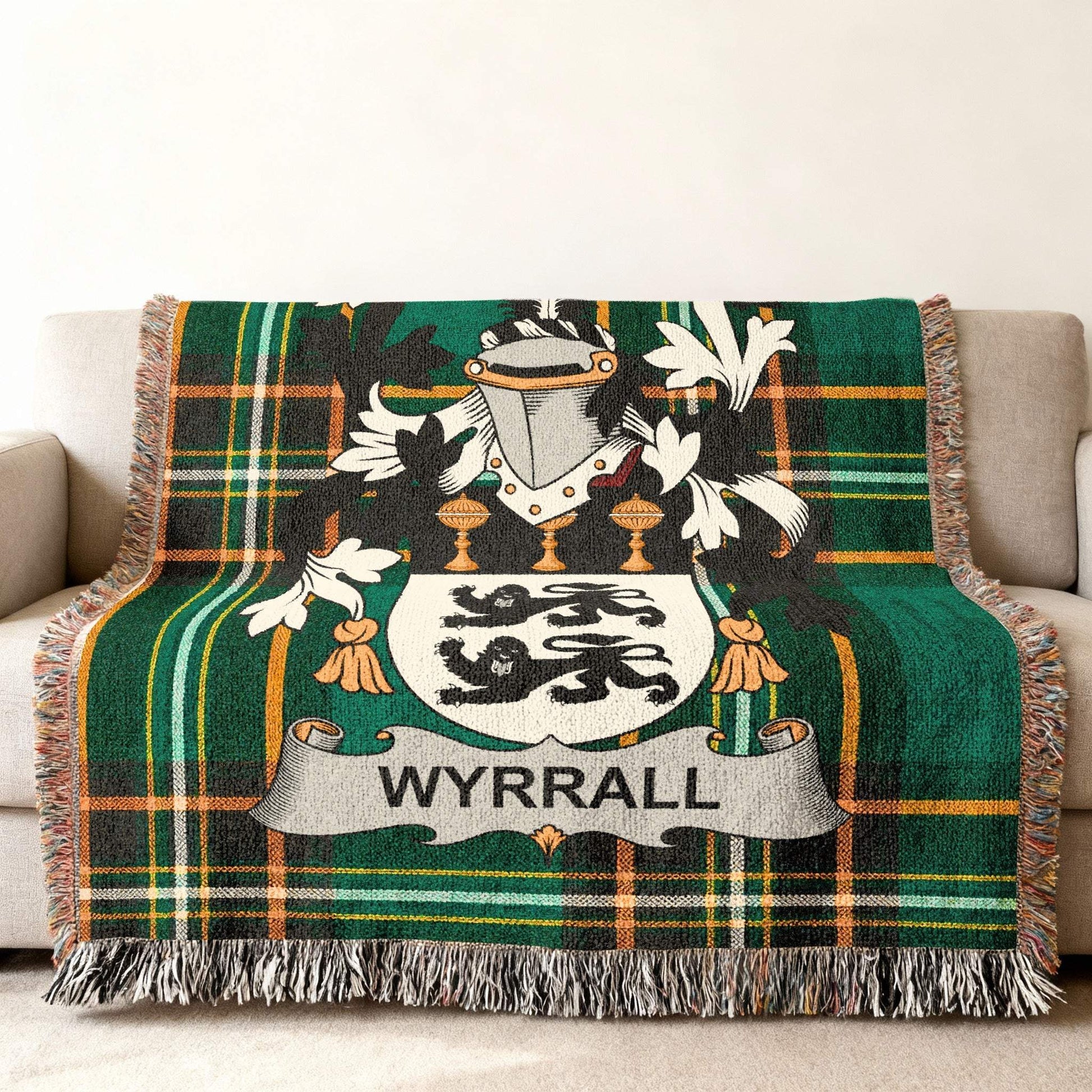 Wyrrall family crest on a green tartan woven throw blanket.