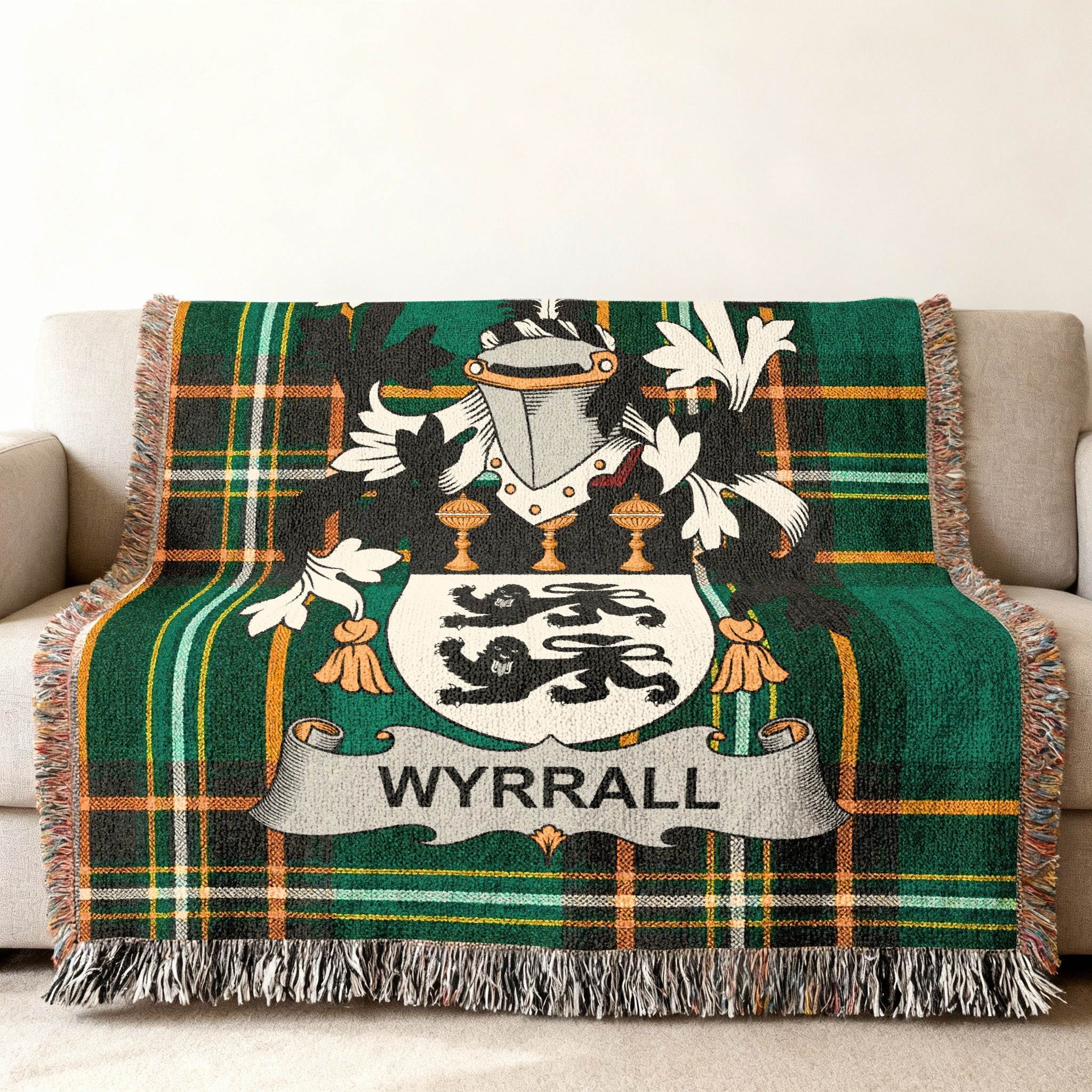 Wyrrall family crest on a green tartan woven throw blanket.