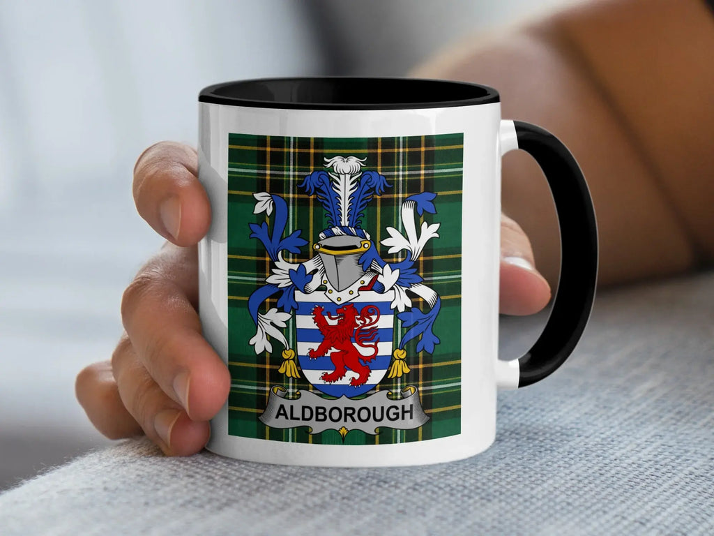 Mug with Aldborough family crest on plaid background.