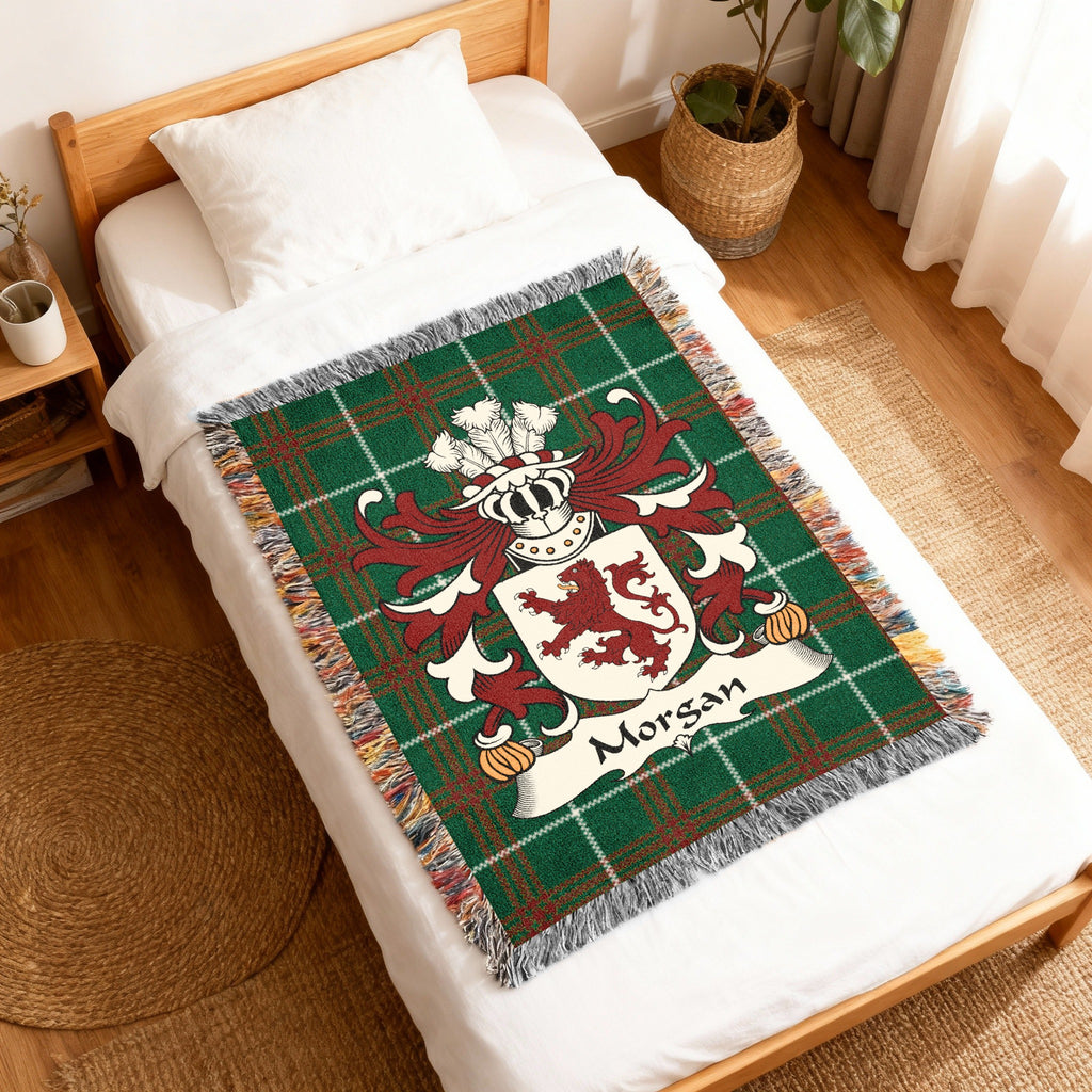 Green tartan throw blanket with Morgan family crest and lion emblem.