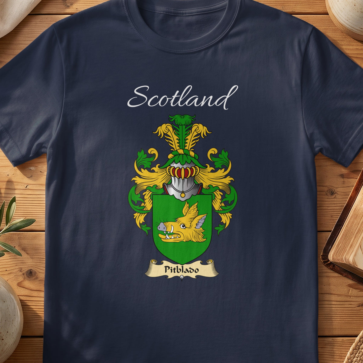 Navy Pitblado heritage T-shirt laid flat with “Scotland” and the colourful family shield design.