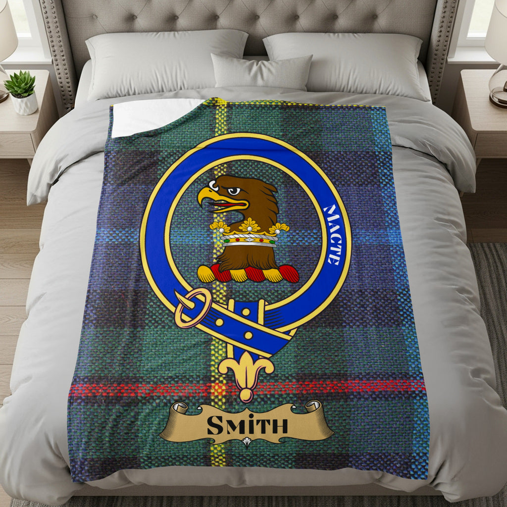Smith clan crest with eagle and Macte motto on tartan throw
