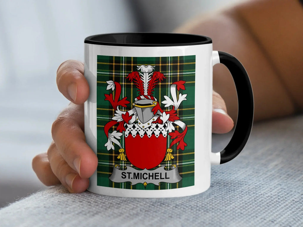White mug with black rim displaying a family crest and "ST. MICHELL" text.