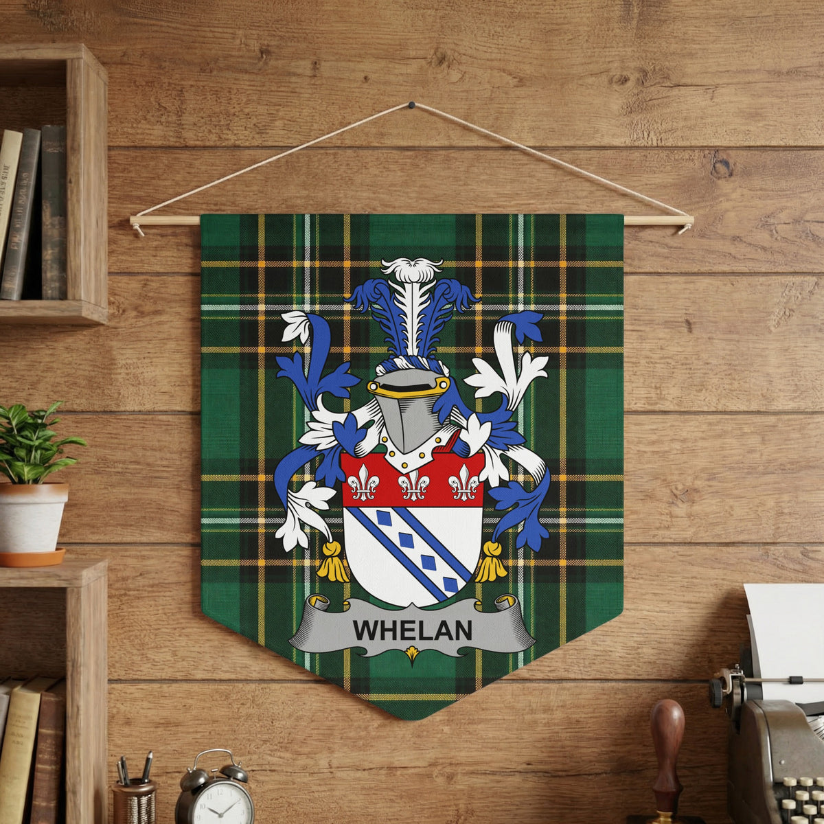 Whelan family crest on green tartan pennant hanging on wooden wall.