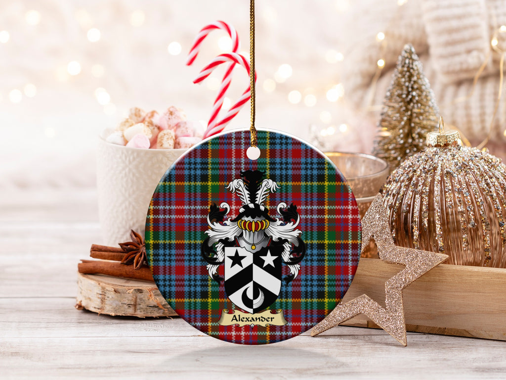 Alexander family emblem ceramic Christmas ornament with Caledonia tartan background in festive holiday décor
