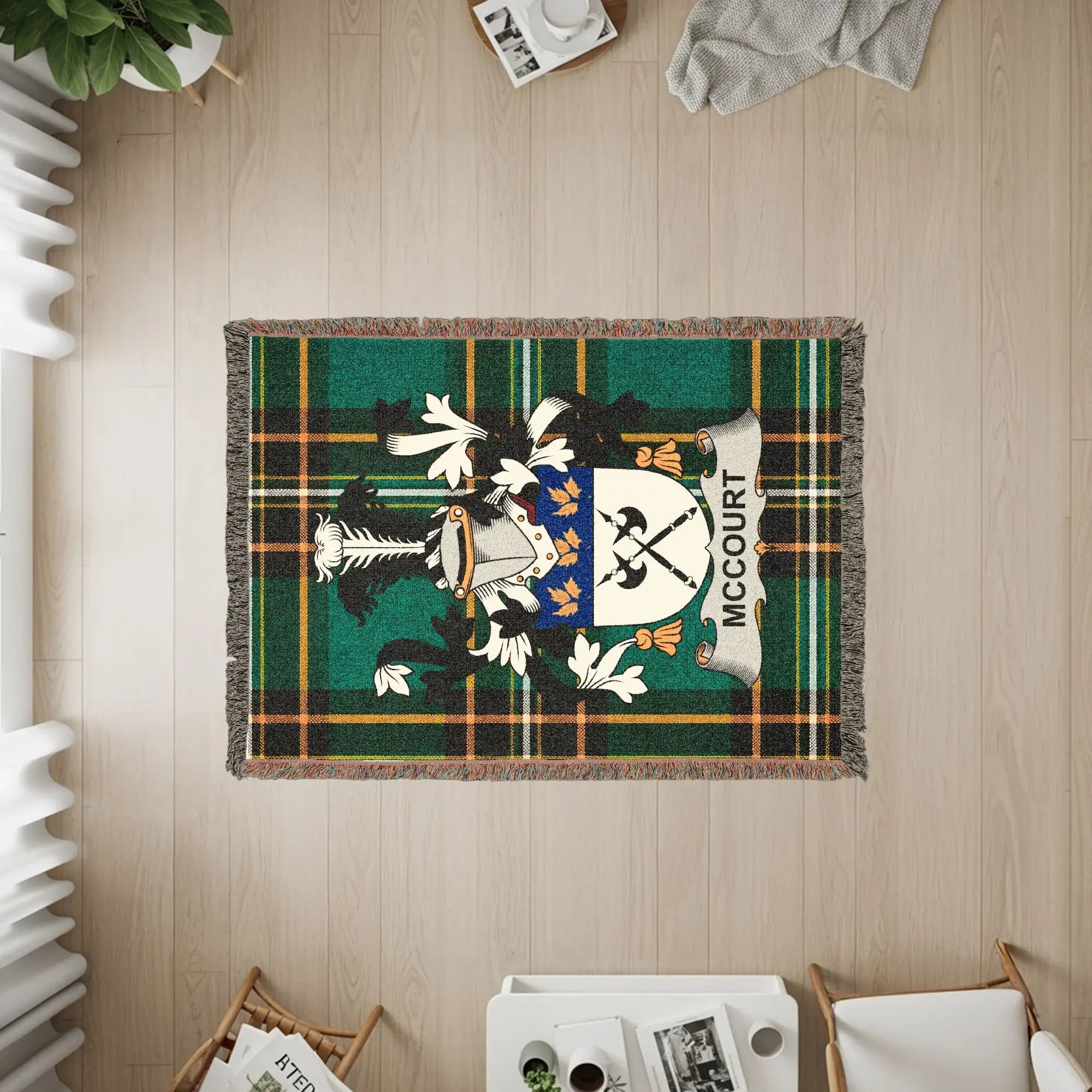 McCourt family crest on a green tartan woven blanket with fringe.