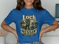 T-shirt with Loch Ness Monster graphic and text.