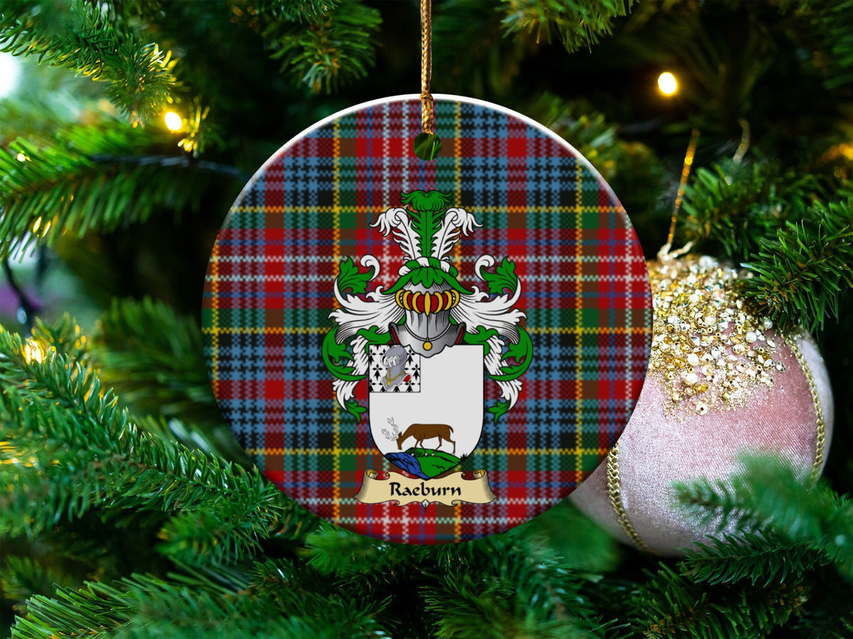 Raeburn Scottish clan ceramic ornament with family crest on a Caledonia tartan background, hanging on a Christmas tree