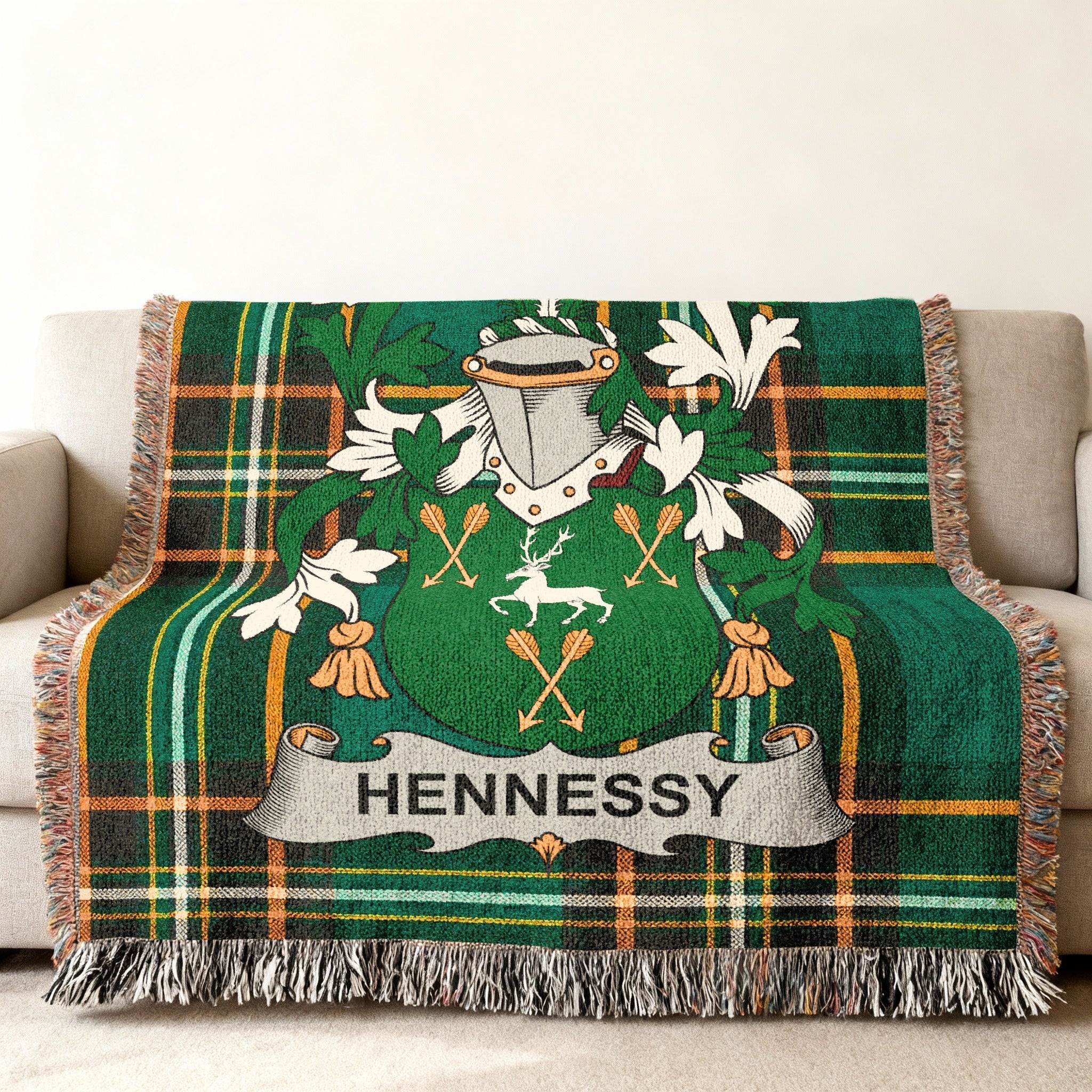 Green tartan blanket featuring the Hennessy family crest with a deer.