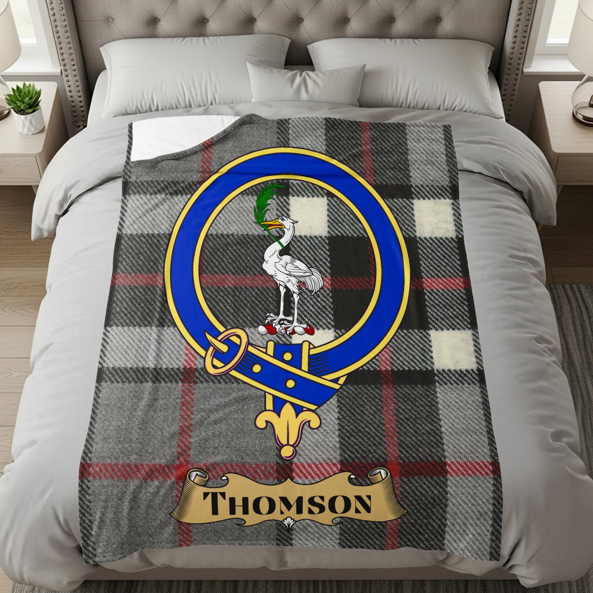 Thomson clan tartan throw with crest and name on a bed
