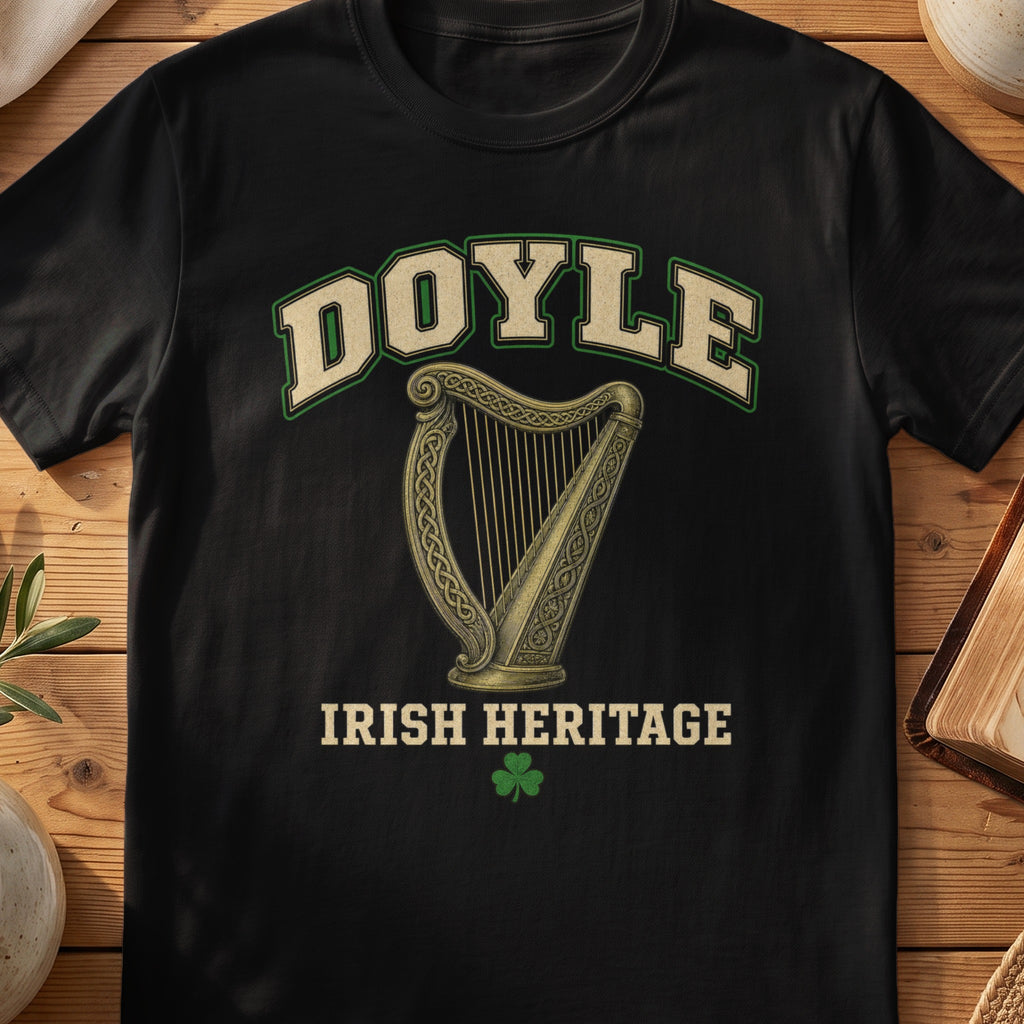 Doyle Irish harp T-shirt in Black, with cream surname lettering, a gold-toned harp, green shamrock and “Irish Heritage” text.
