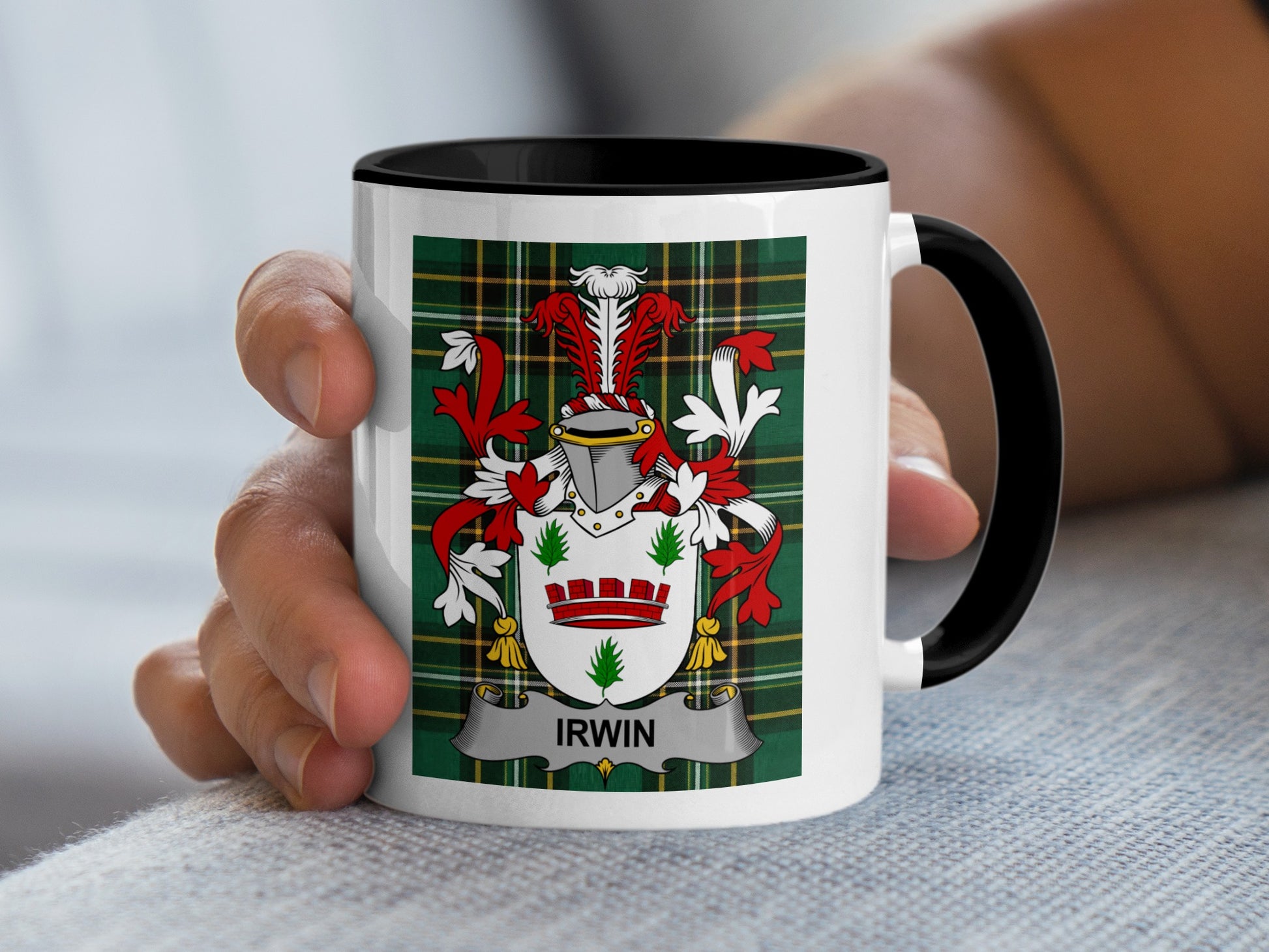 White mug with black rim featuring a green plaid background and the crest "IRWIN".