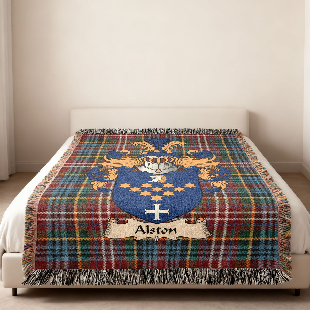 Alston family crest emblem on a Caledonia tartan woven blanket