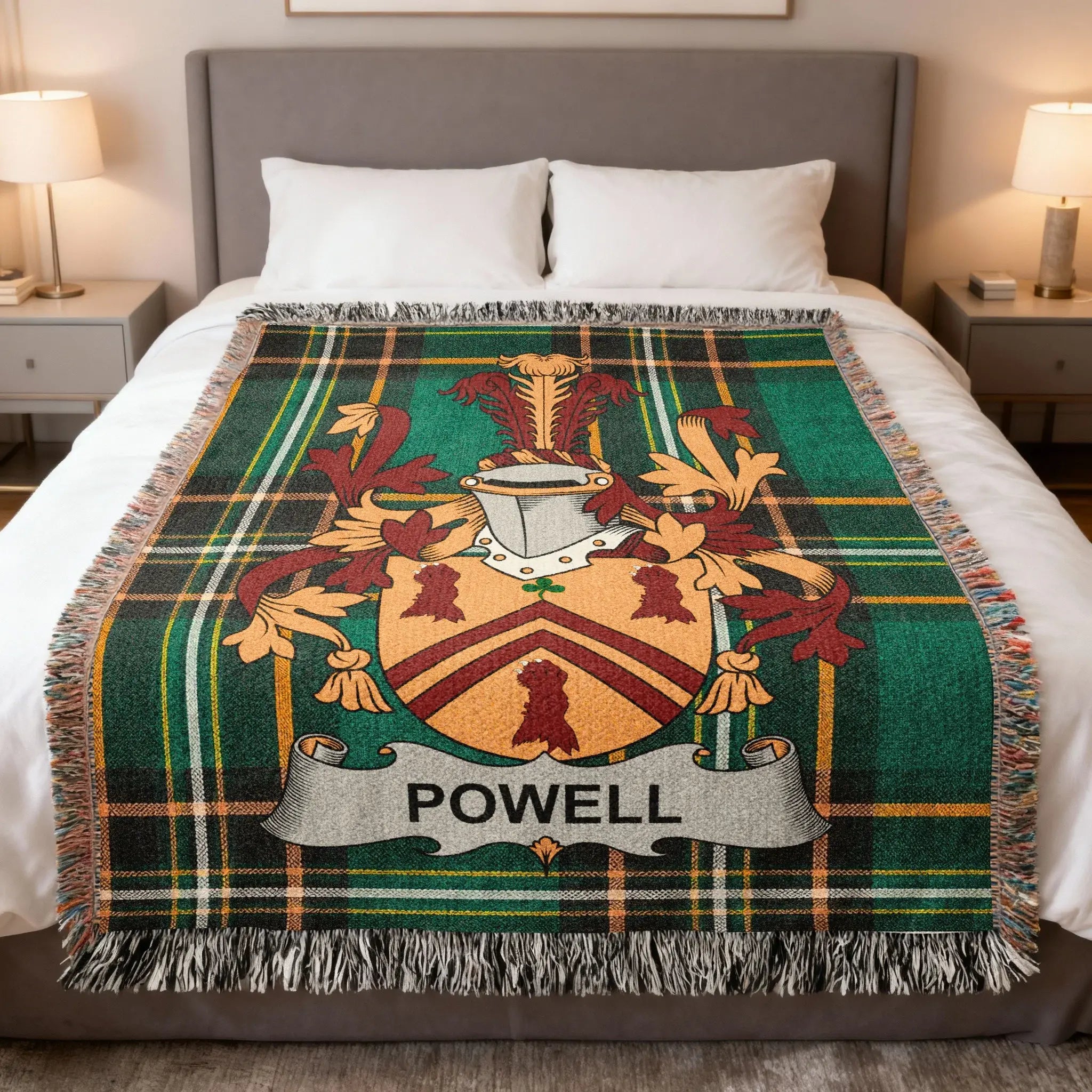 Powell family crest on a green plaid woven blanket on a bed.