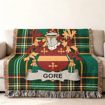 Tartan blanket with Gore family crest on a couch.