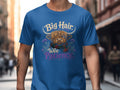 Highland cow graphic with text "Big Hair Wee Patience" on a blue t-shirt.