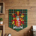 O'BRIEN family crest displayed on a green tartan pennant hanging on a wooden wall.