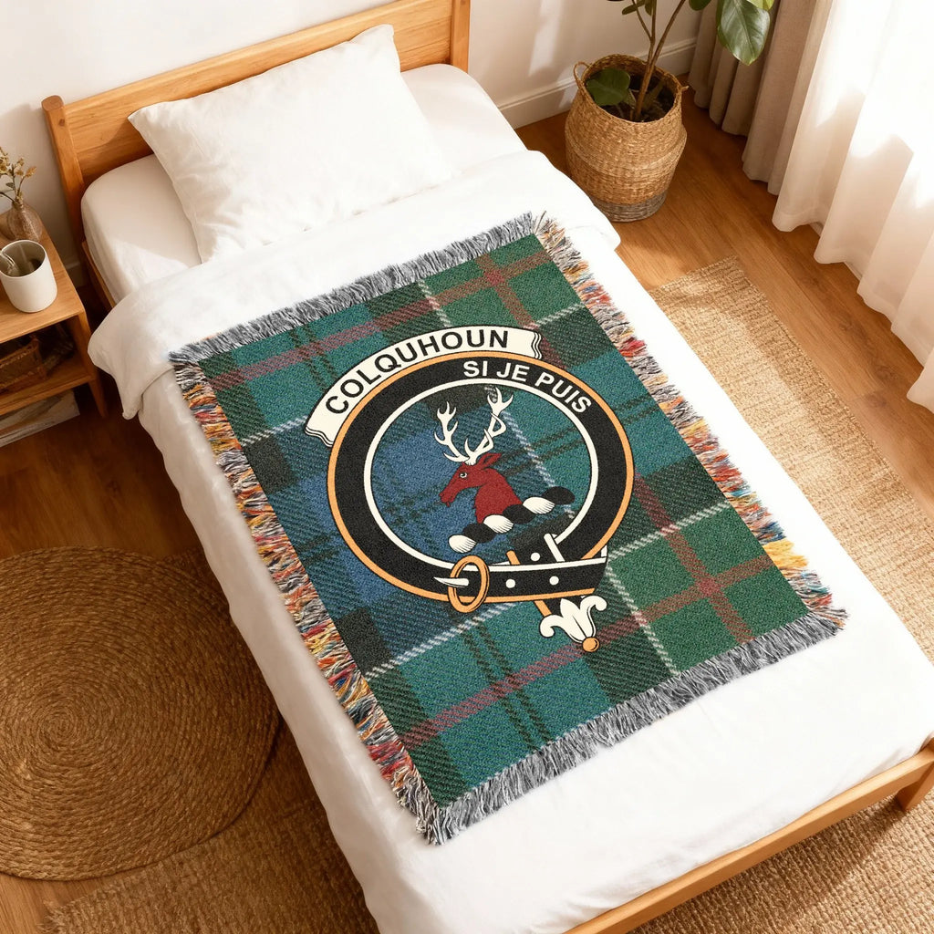 Colquhoun clan crest plaid woven blanket folded — tartan weave with stag heraldic design