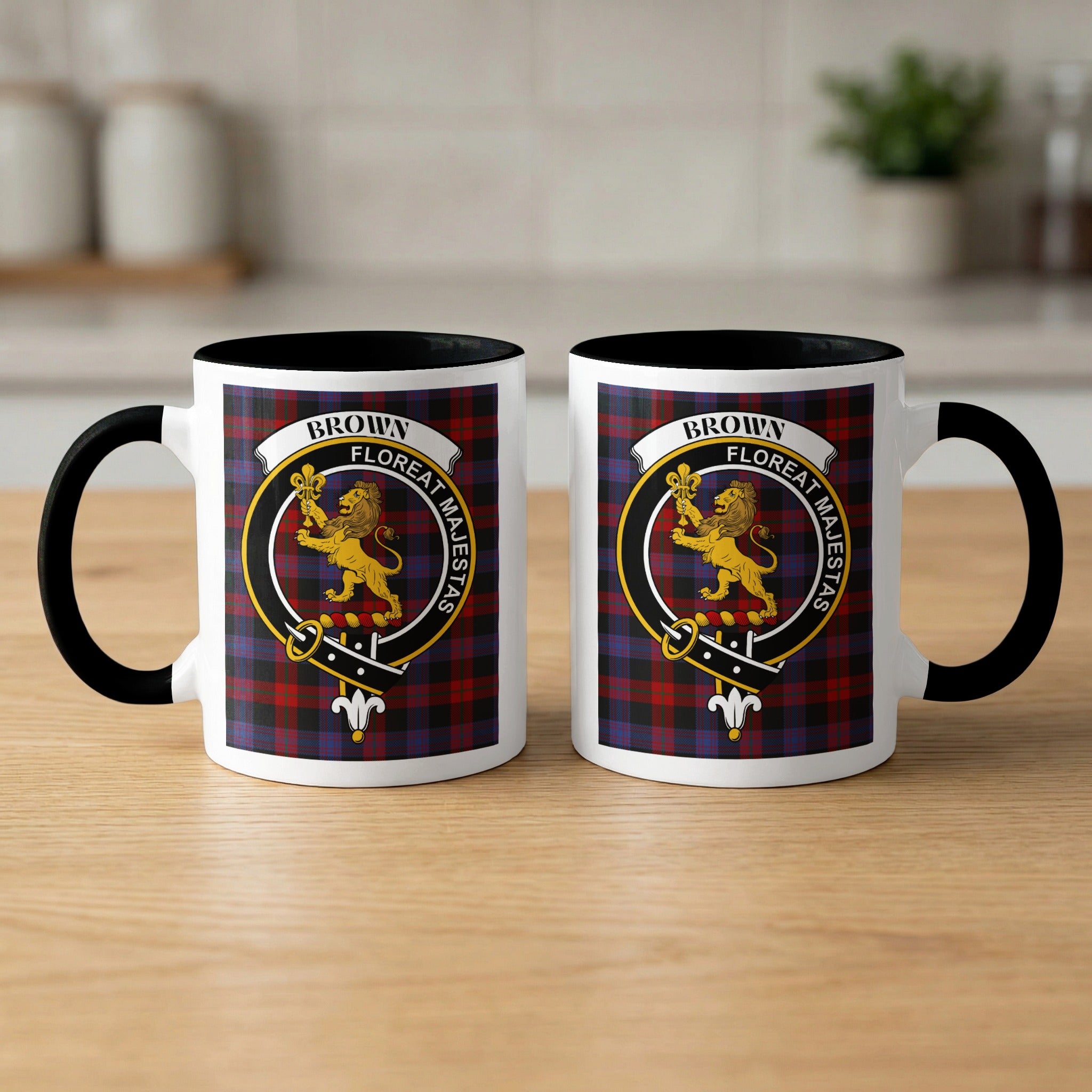 Brown family crest mugs side by side — tartan background, front and back