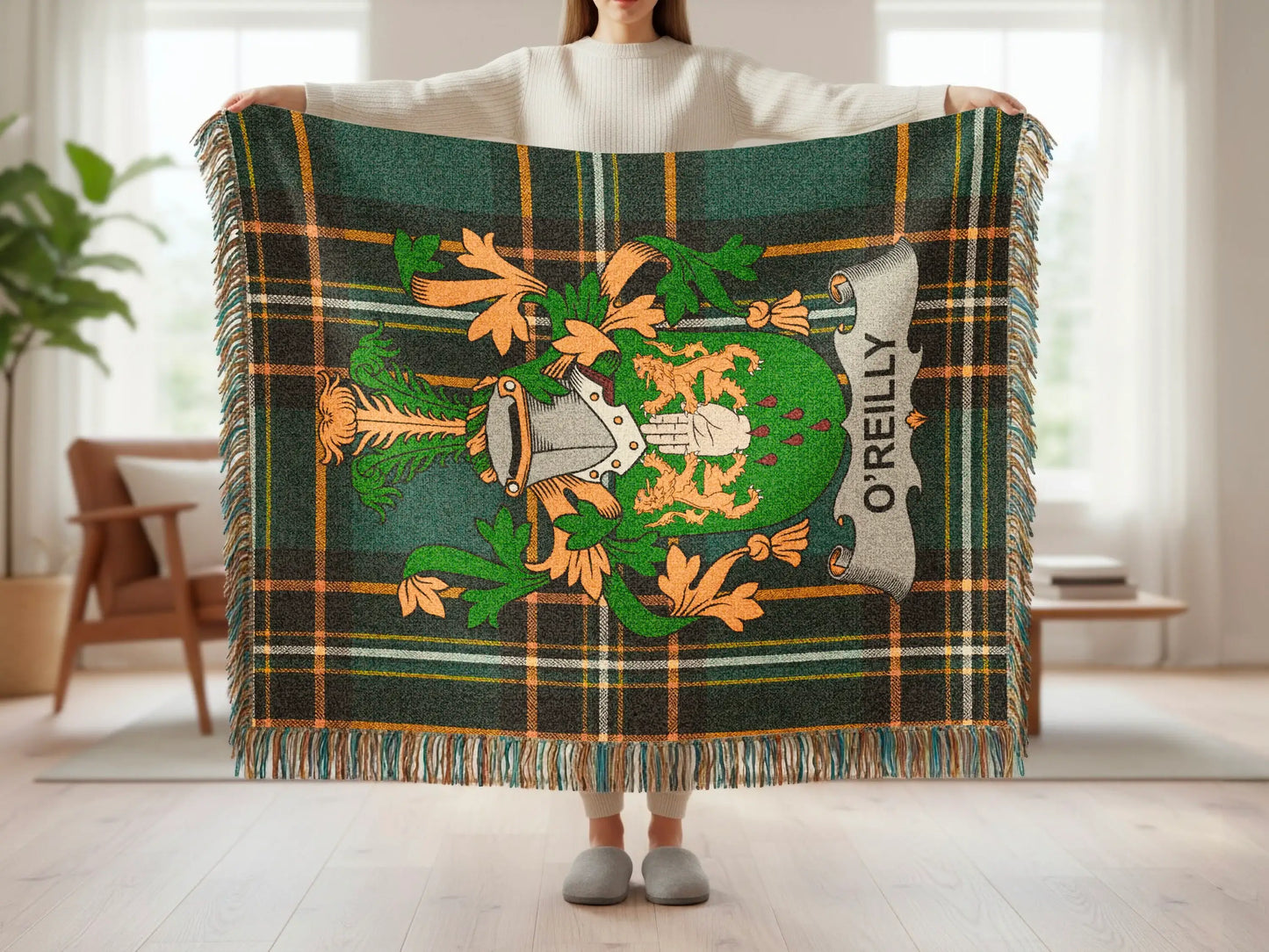 Green plaid blanket with O'Reilly crest and fringe, held by a person.