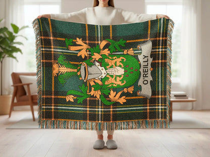Green plaid blanket with O'Reilly crest and fringe, held by a person.