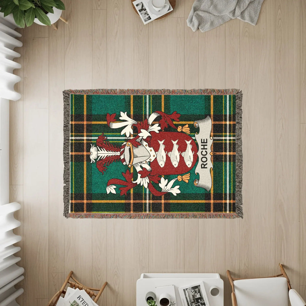 Roche family crest woven blanket with green and red plaid border.