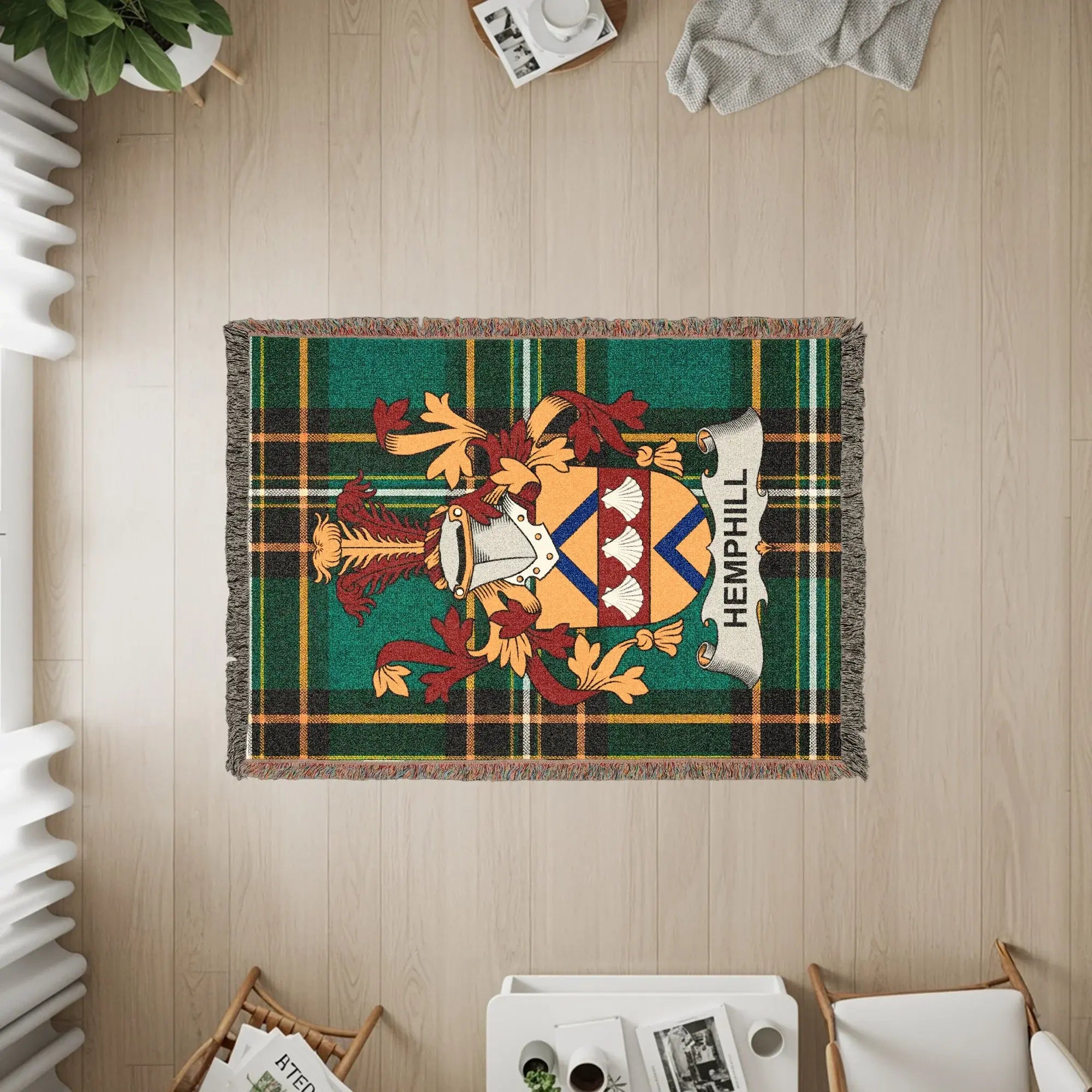 Woven blanket with Hemphill family crest on green plaid background.