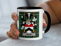 White mug with black rim displaying green tartan and "Tierney" coat of arms.