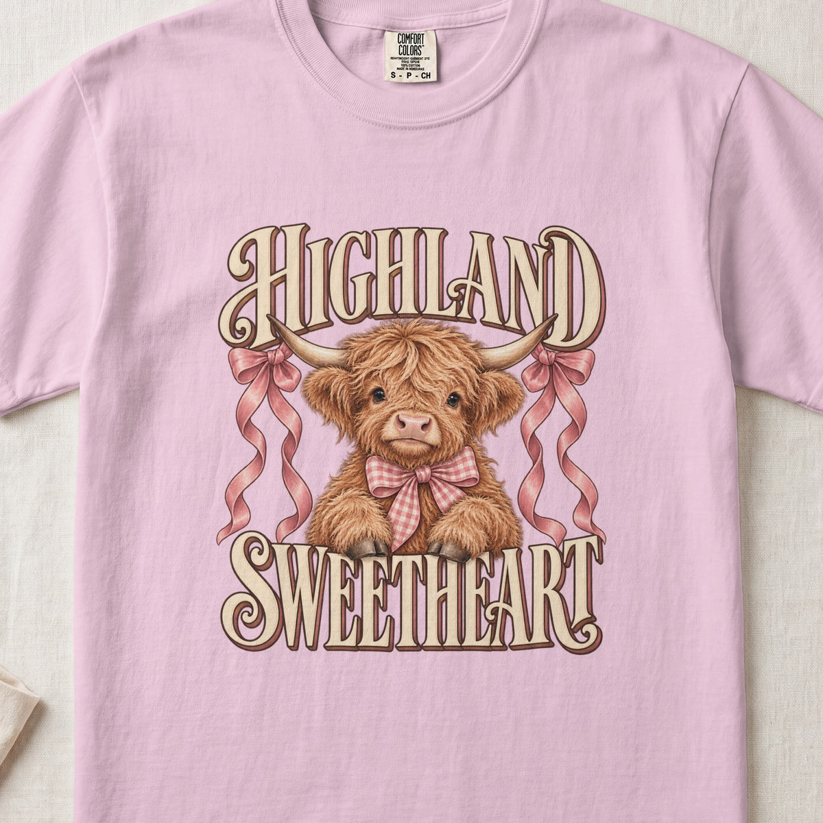 Highland Sweetheart Highland cow design on a Blossom Comfort Colors 1717 T-shirt, flat lay