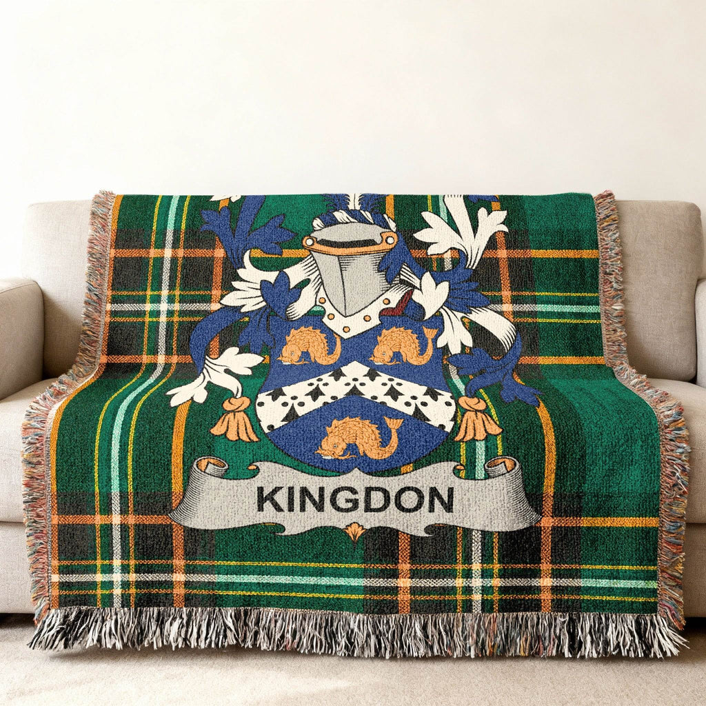 Woven throw blanket featuring the Kingdon family crest on a green plaid background.