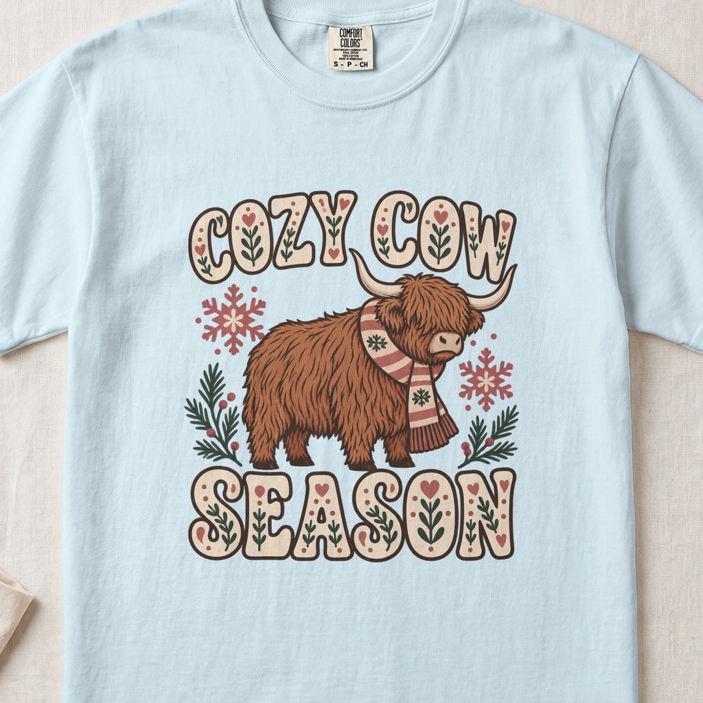 Cozy Cow Season Highland cow design on a Chambray Comfort Colors 1717 T-shirt, flat lay