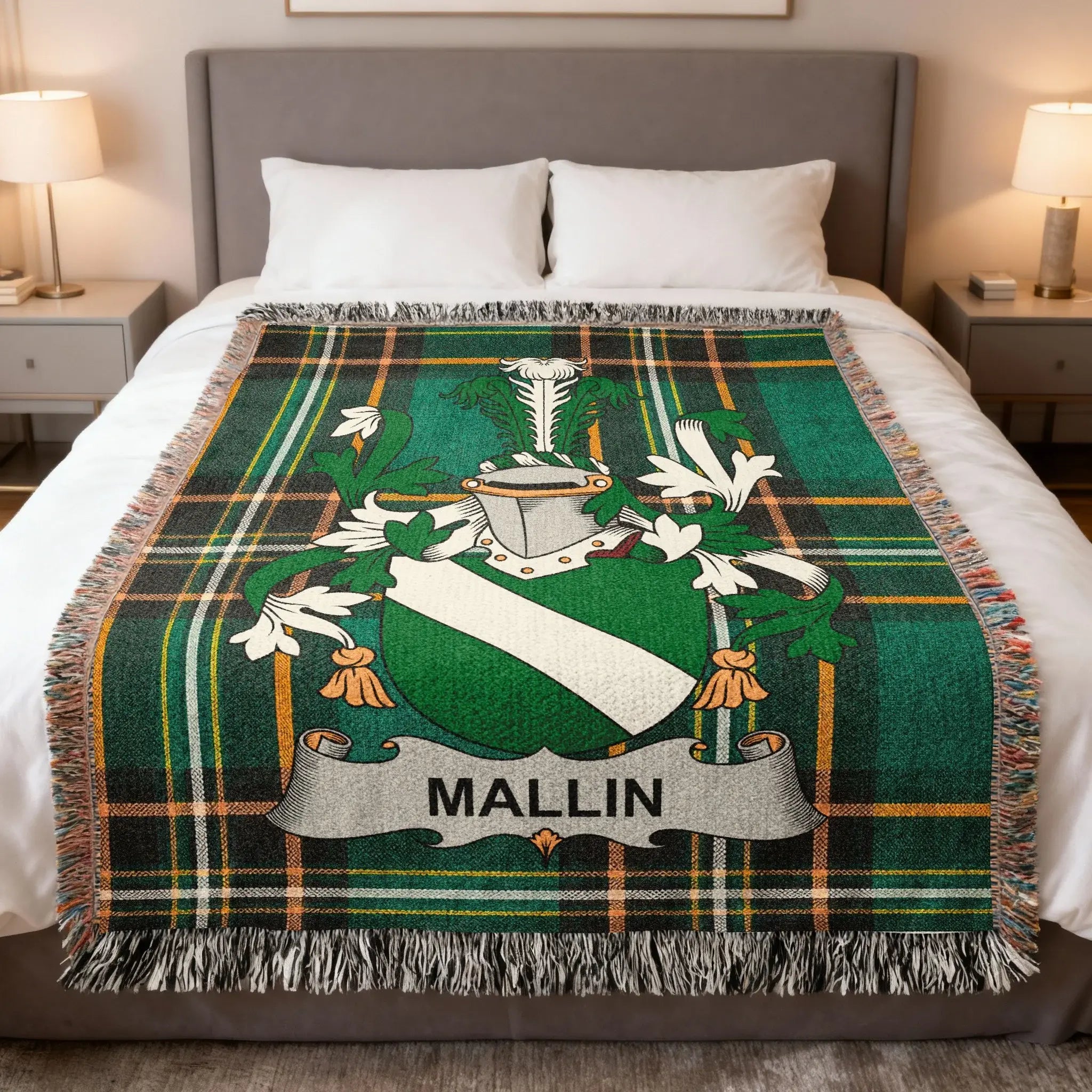 Tartan blanket featuring the Mallin family crest over a bed.