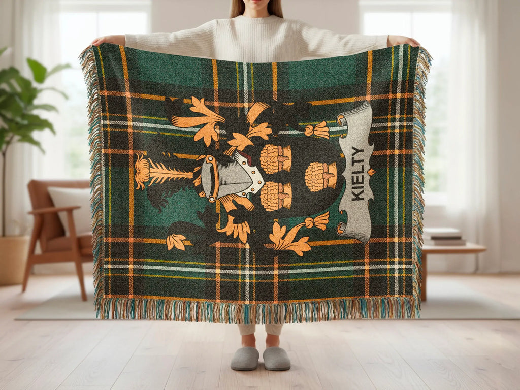 Kielty tartan blanket with crest and fringed edges.