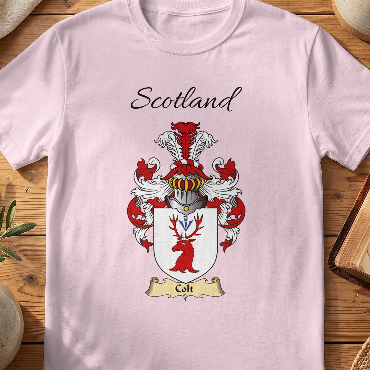 Light Pink Colt Scottish family shield T-shirt featuring a red stag head with blue details