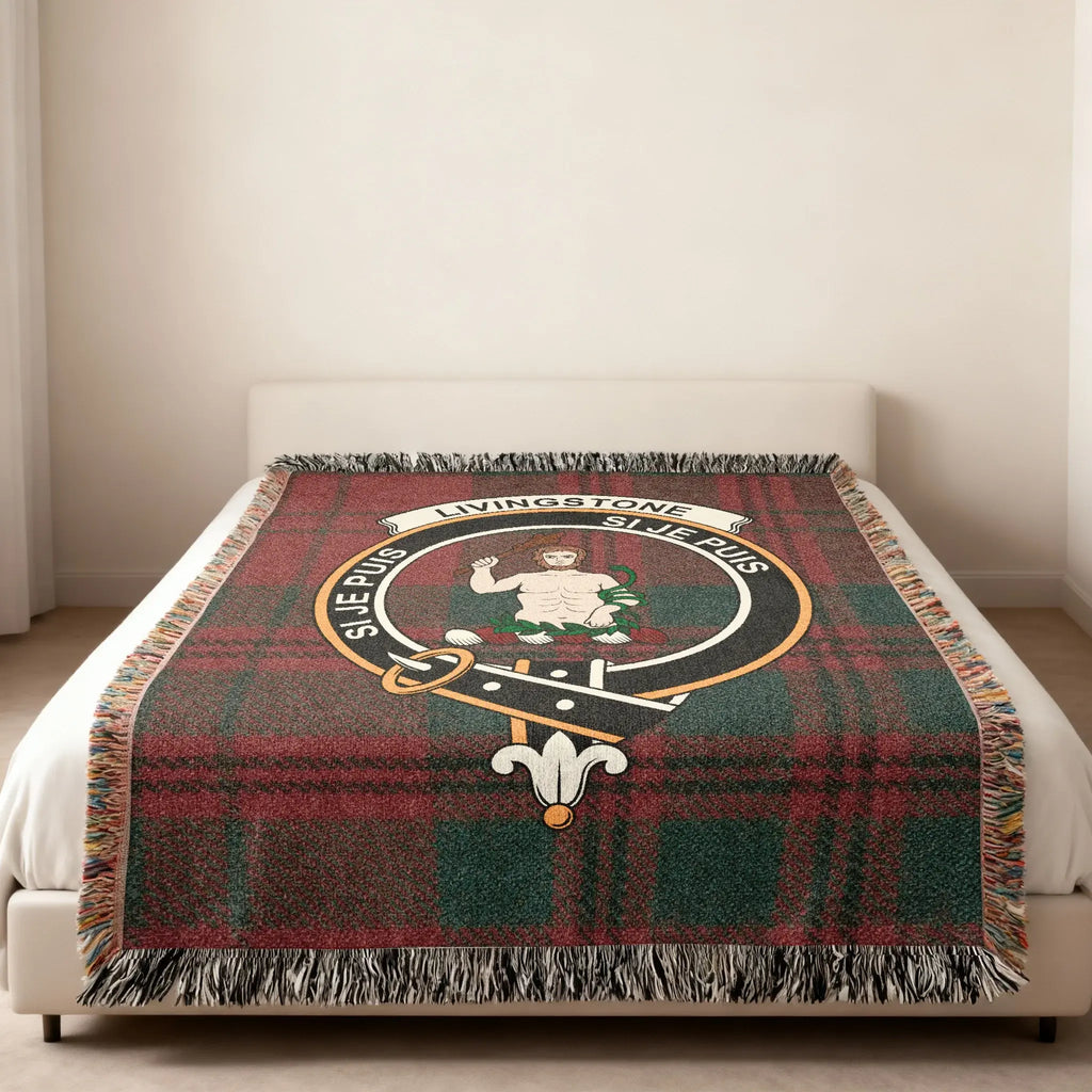 Clan Livingstone tartan woven blanket — lifestyle shot showing Si Je Puis motto and fringe border