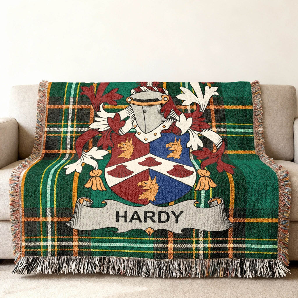 Green tartan throw blanket with Hardy family crest.