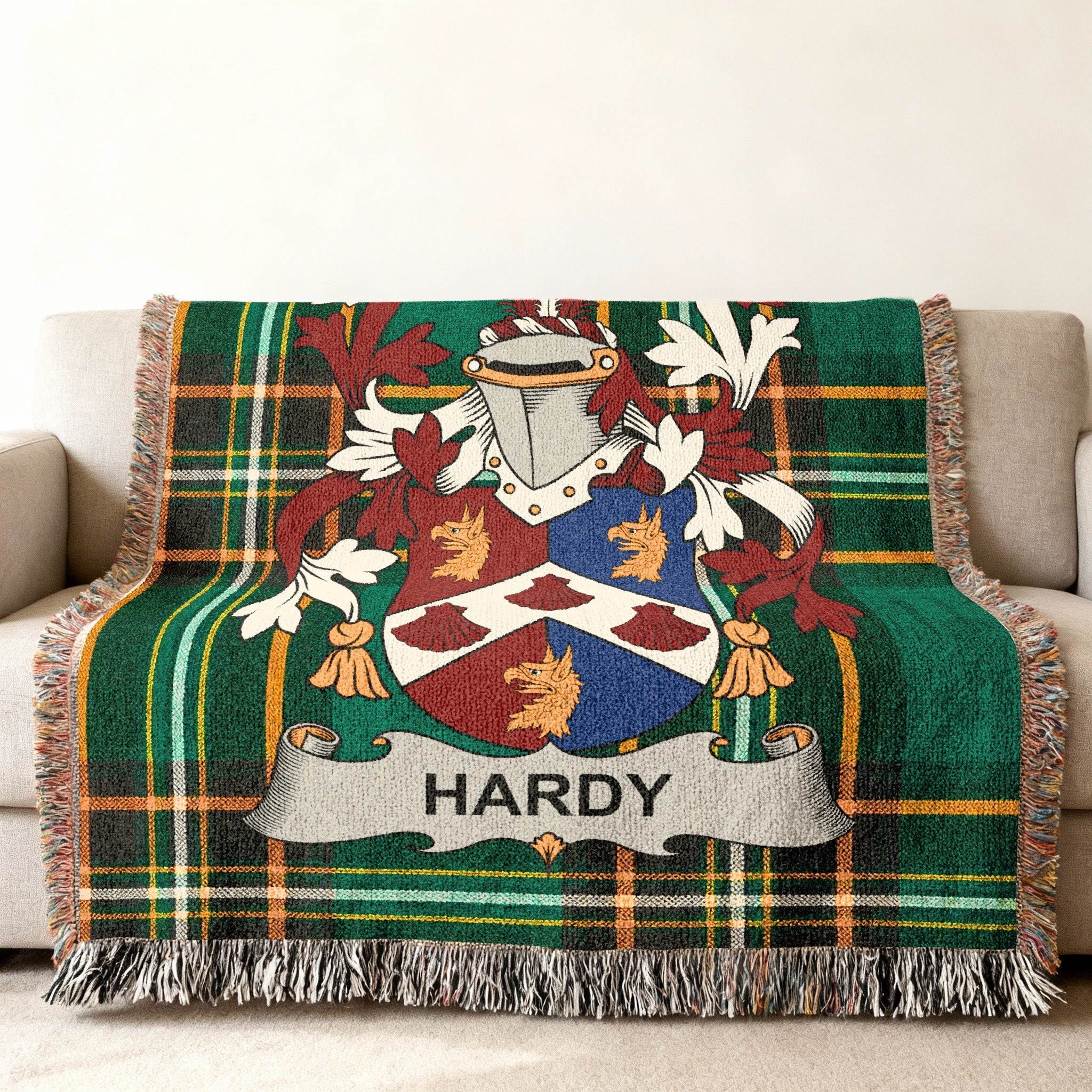 Green tartan throw blanket with Hardy family crest.
